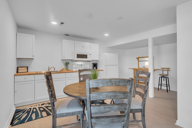 1704 Little Dr, Horton, MI 49246 - dining room featuring recessed lighting, baseboards, visible vents, and light wood-style flooring