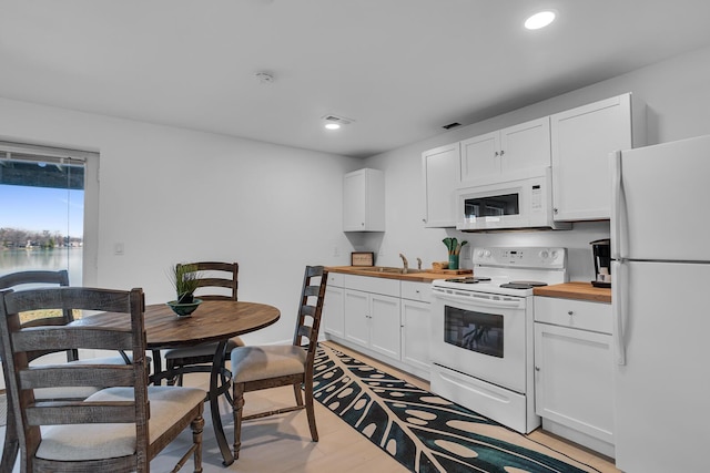 1704 Little Dr, Horton, MI 49246 - kitchen featuring recessed lighting, wooden counters, white cabinets, and white appliances