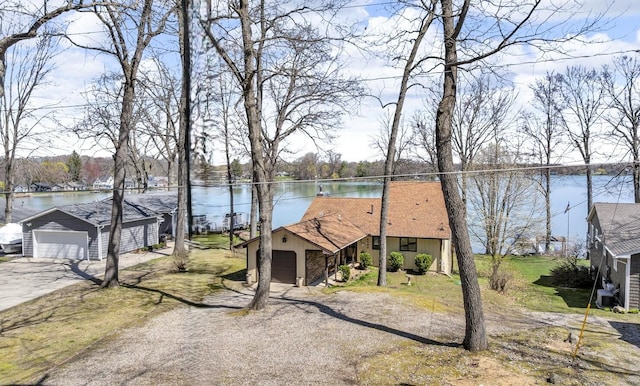 1704 Little Dr, Horton, MI 49246 - view of front of home featuring a garage, an outdoor structure, a water view, and driveway