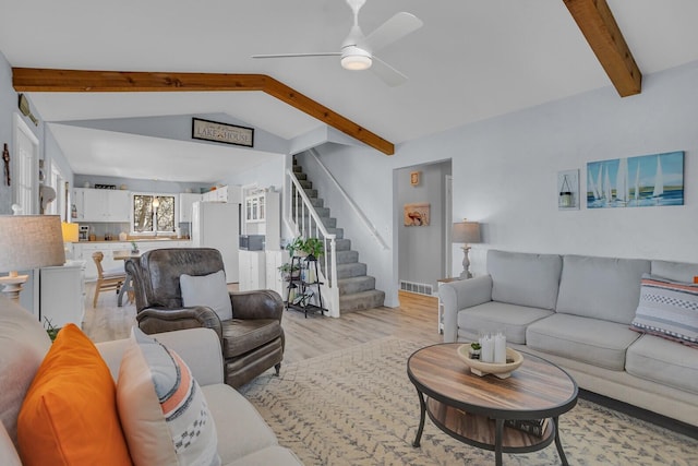 1704 Little Dr, Horton, MI 49246 - living area with ceiling fan, visible vents, stairway, lofted ceiling with beams, and light wood-style flooring