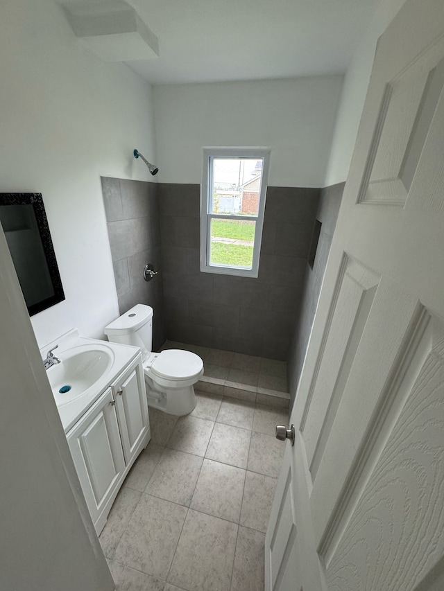 6209 Oldtown St, Detroit, MI 48224 - bathroom featuring vanity, tile patterned flooring, toilet, and tiled shower