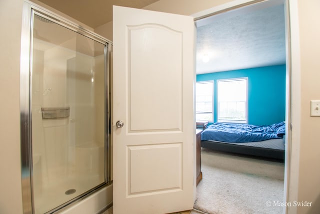 full bathroom with ensuite bathroom and a stall shower