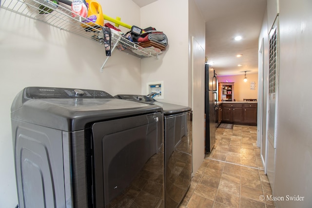 laundry area with stone finish floor, laundry area, recessed lighting, and washing machine and clothes dryer