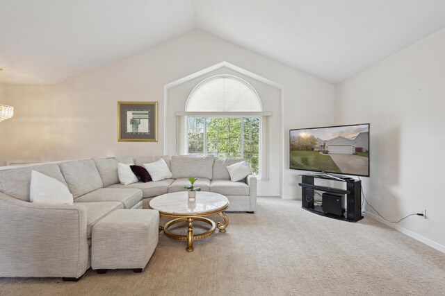3332 Hampton Downs Dr SE, Kentwood, MI 49512 - living room featuring baseboards, carpet, vaulted ceiling, and a chandelier