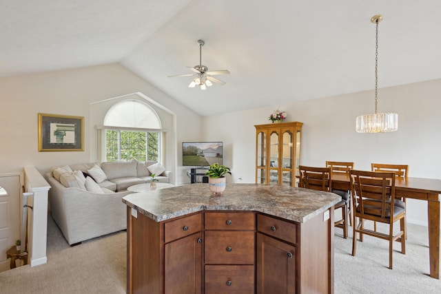 3332 Hampton Downs Dr SE, Kentwood, MI 49512 - kitchen featuring ceiling fan with notable chandelier, a center island, light carpet, and vaulted ceiling
