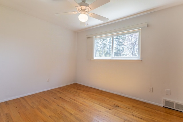 unfurnished room with visible vents, a ceiling fan, baseboards, and light wood-type flooring