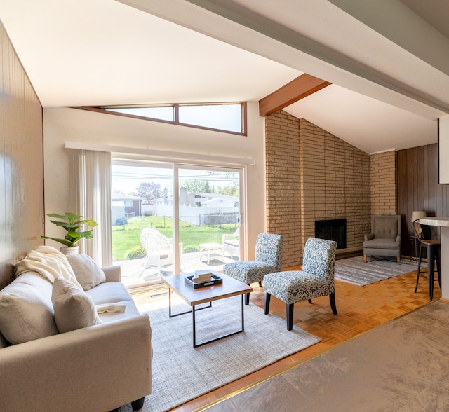 living room featuring vaulted ceiling with beams and a fireplace
