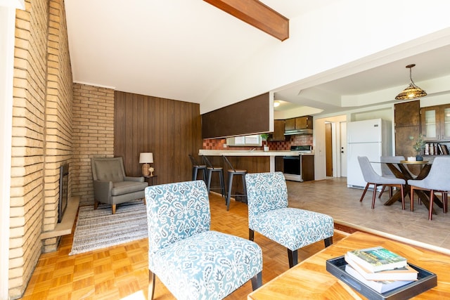 living room featuring wooden walls and vaulted ceiling with beams