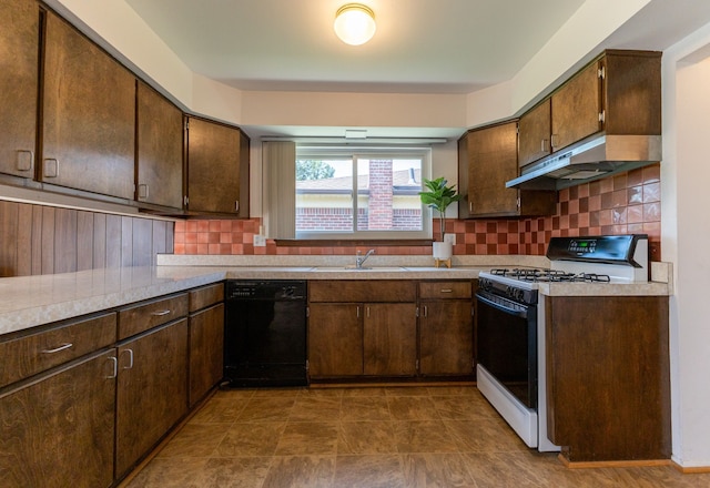 kitchen featuring under cabinet range hood, tasteful backsplash, a sink, dishwasher, and range with gas cooktop