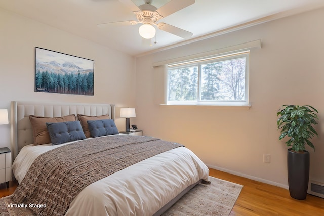 bedroom featuring baseboards, ceiling fan, and light wood-type flooring