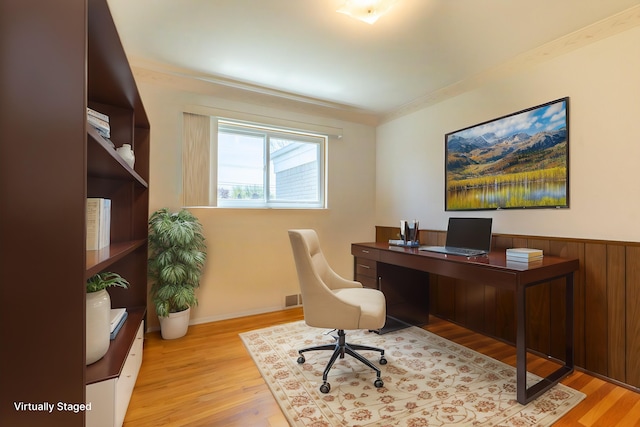 office with visible vents, ornamental molding, and wood finished floors