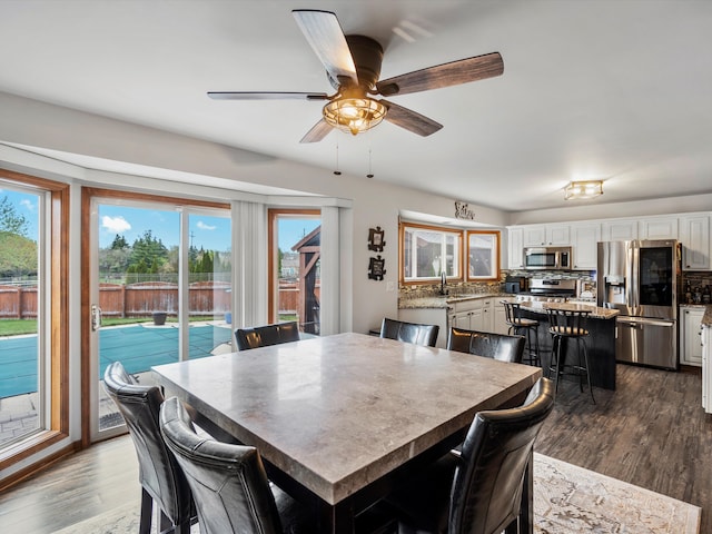 dining room featuring dark wood-type flooring and ceiling fan