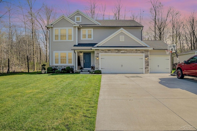 craftsman-style home featuring a garage, stone siding, concrete driveway, and a front yard