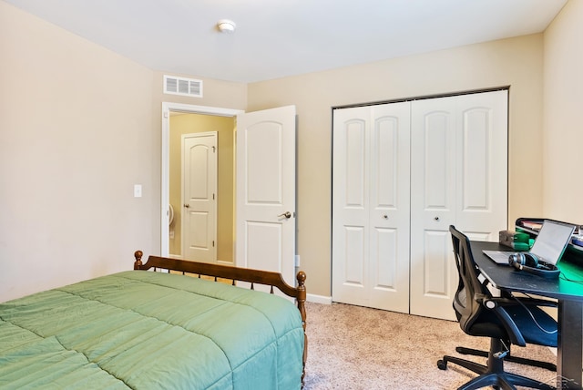 bedroom featuring a closet, baseboards, light colored carpet, and visible vents