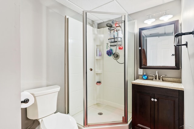 full bathroom featuring vanity, a shower stall, and toilet