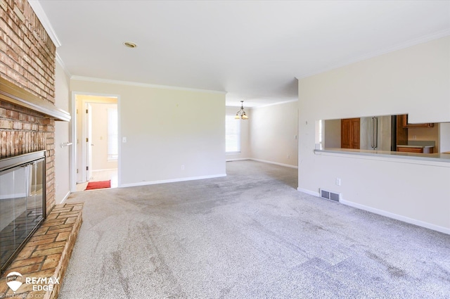 unfurnished living room featuring a brick fireplace, visible vents, ornamental molding, and carpet floors