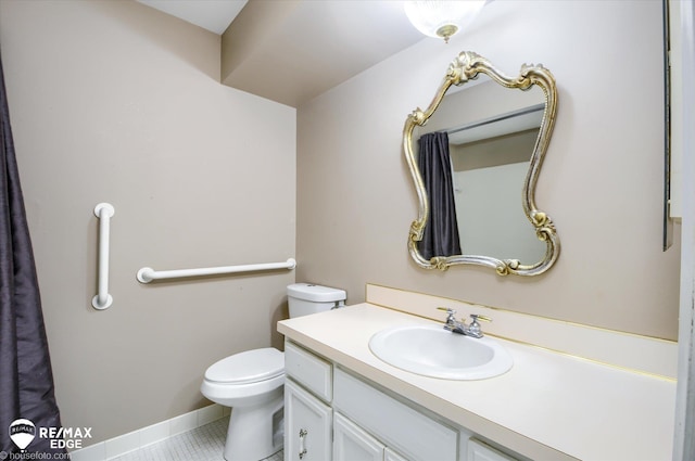 bathroom with vanity, tile patterned floors, and toilet