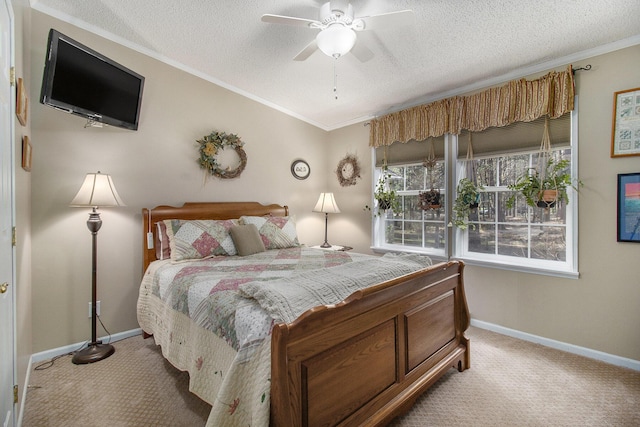 carpeted bedroom featuring crown molding, a textured ceiling, baseboards, and ceiling fan