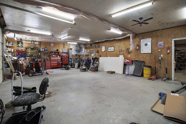 garage featuring a workshop area and a ceiling fan