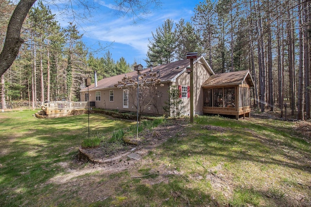 view of yard with a wooden deck and a sunroom