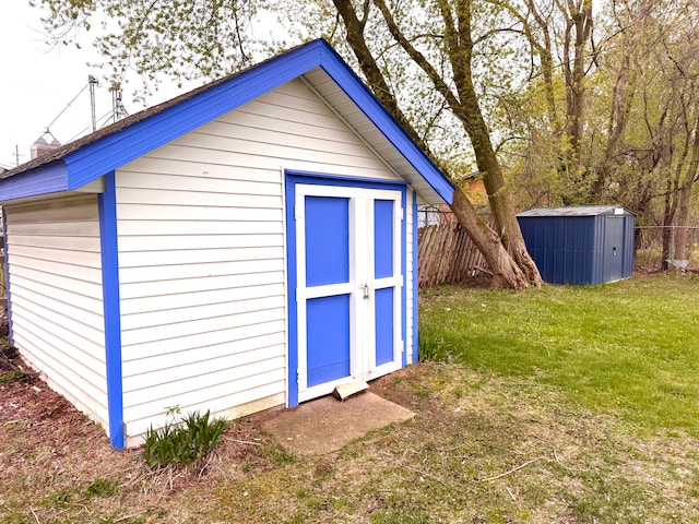 view of shed featuring fence