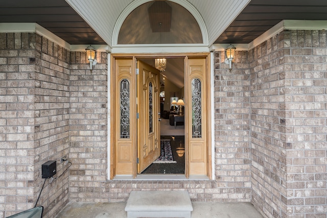 view of exterior entry with brick siding