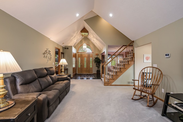 living room with carpet floors, visible vents, stairs, baseboards, and high vaulted ceiling