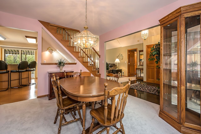 carpeted dining space featuring stairs and an inviting chandelier