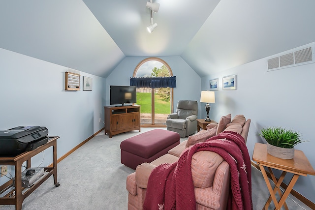 carpeted living area featuring baseboards, visible vents, and vaulted ceiling
