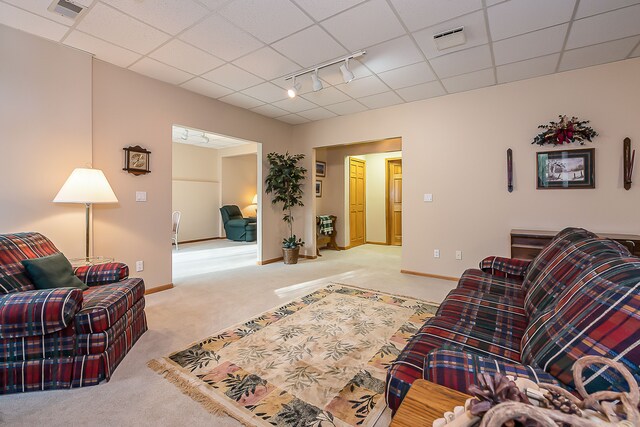 living room featuring visible vents, rail lighting, baseboards, light carpet, and a drop ceiling