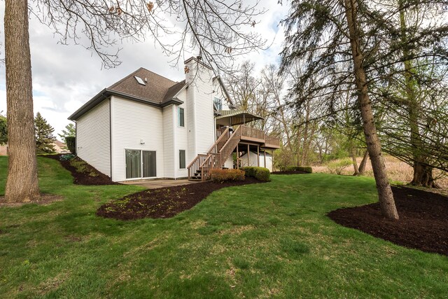 back of property with stairs, a wooden deck, a chimney, a patio, and a yard