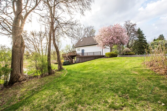view of yard with a wooden deck and stairway