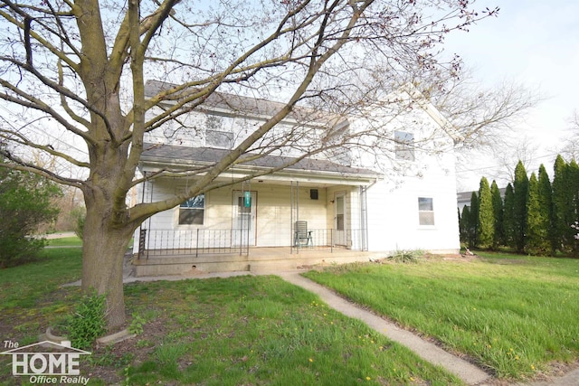 view of front of home with a porch and a front lawn