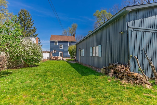 back of property featuring a lawn and board and batten siding