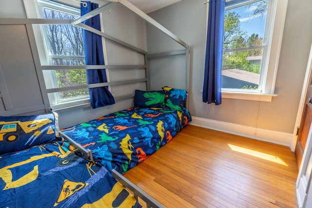 bedroom featuring baseboards and wood finished floors