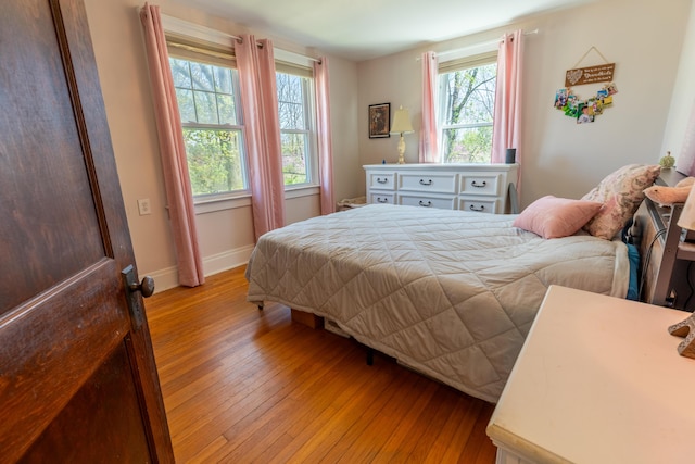 bedroom featuring light wood-type flooring and baseboards