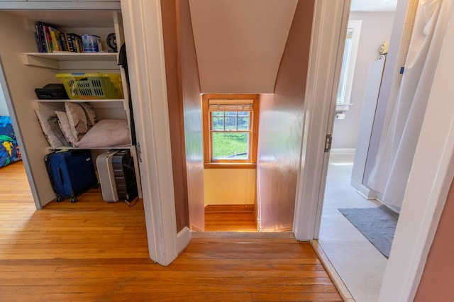 hallway with baseboards and light wood finished floors