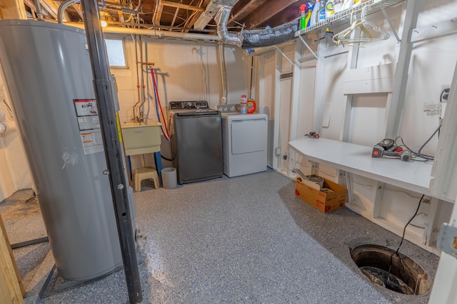 basement featuring water heater, separate washer and dryer, concrete block wall, and a sink