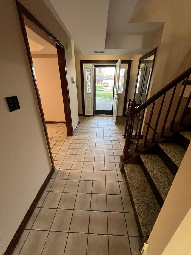 36125 Beverly Dr, Sterling Heights, MI 48310 - foyer with stairs, baseboards, visible vents, and light tile patterned floors