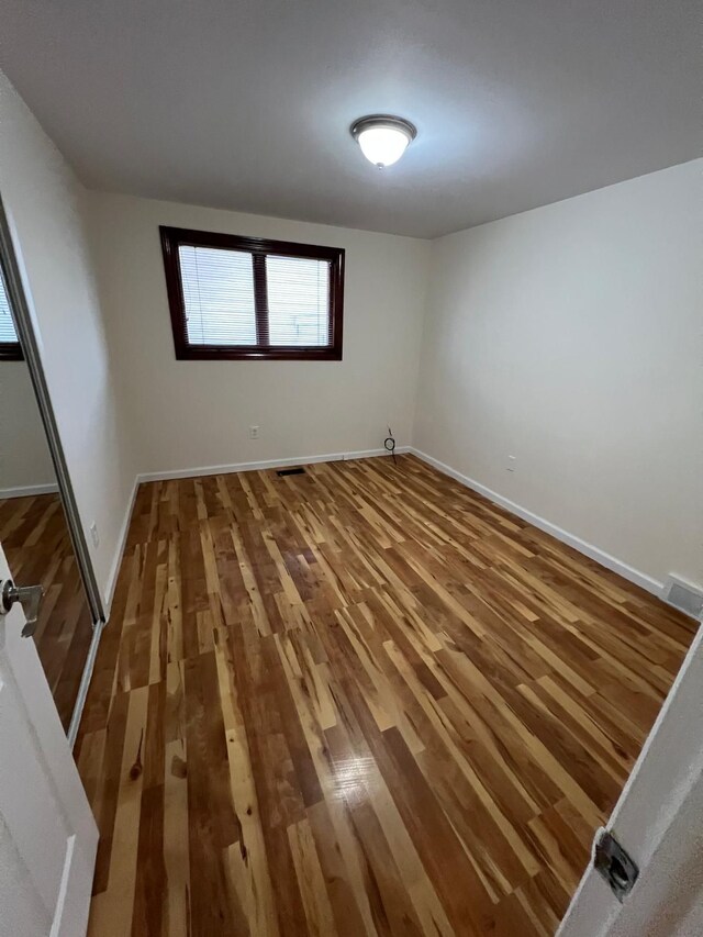 36125 Beverly Dr, Sterling Heights, MI 48310 - empty room with baseboards and wood finished floors
