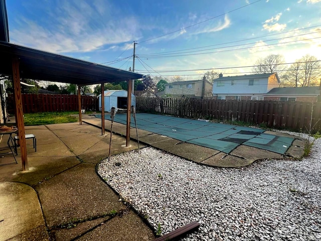 36125 Beverly Dr, Sterling Heights, MI 48310 - view of pool featuring an outdoor structure, a patio, a fenced backyard, a shed, and a fenced in pool