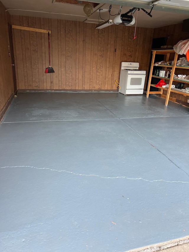 36125 Beverly Dr, Sterling Heights, MI 48310 - garage featuring wood walls and a garage door opener