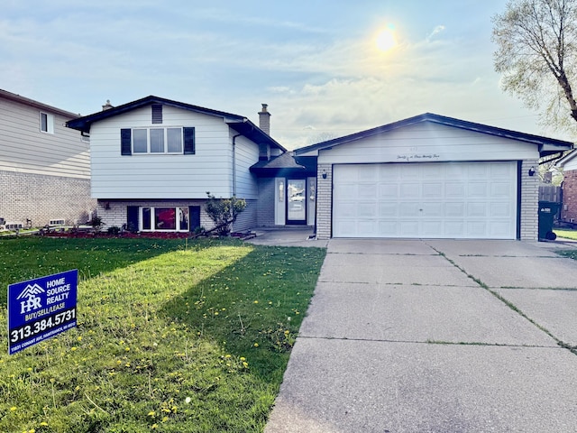 36125 Beverly Dr, Sterling Heights, MI 48310 - split level home featuring brick siding, an attached garage, driveway, and a front yard