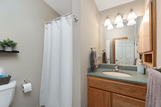 bathroom with vanity, toilet, and curtained shower