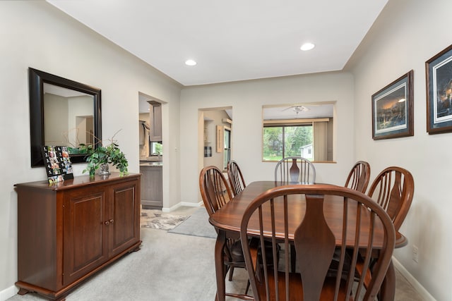 dining space with recessed lighting, baseboards, and light colored carpet