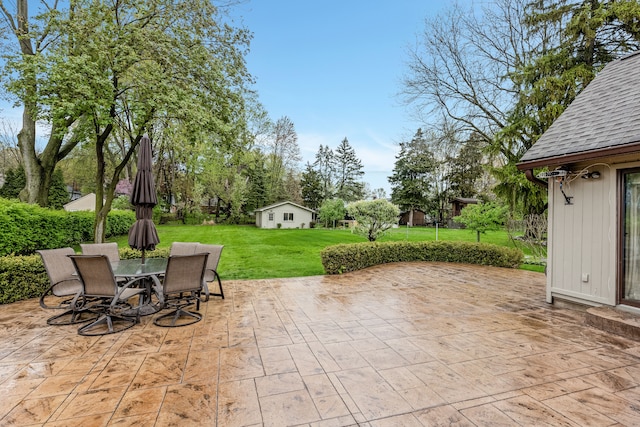 view of patio featuring outdoor dining space and an outdoor structure