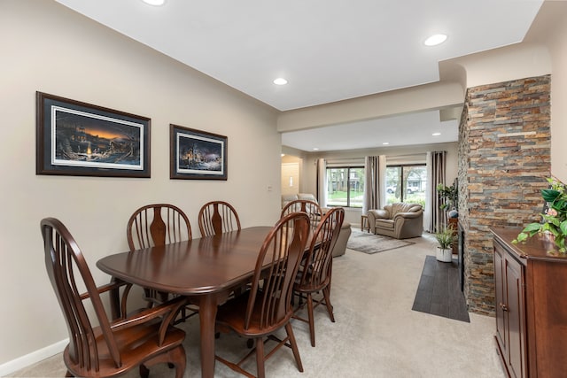 dining space with recessed lighting and light colored carpet
