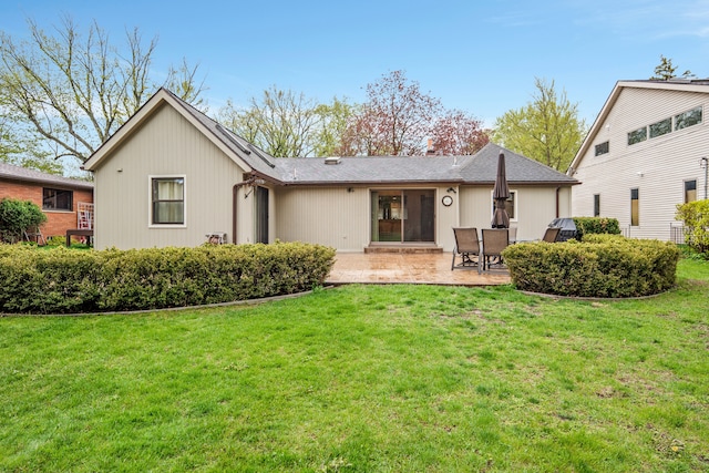 back of house featuring a patio and a lawn