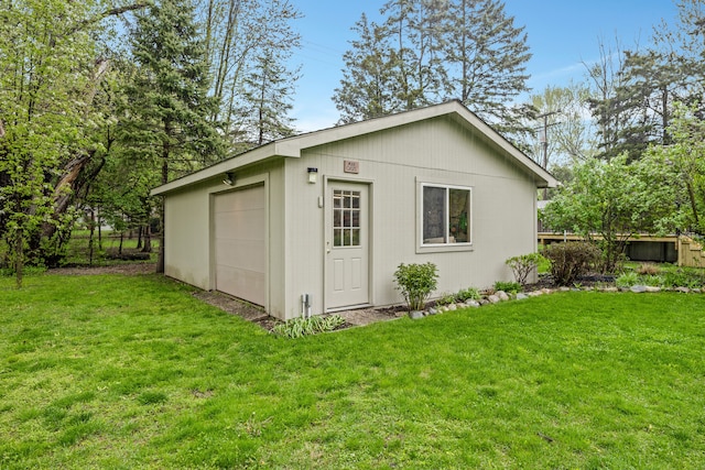 view of outdoor structure with fence and an outbuilding