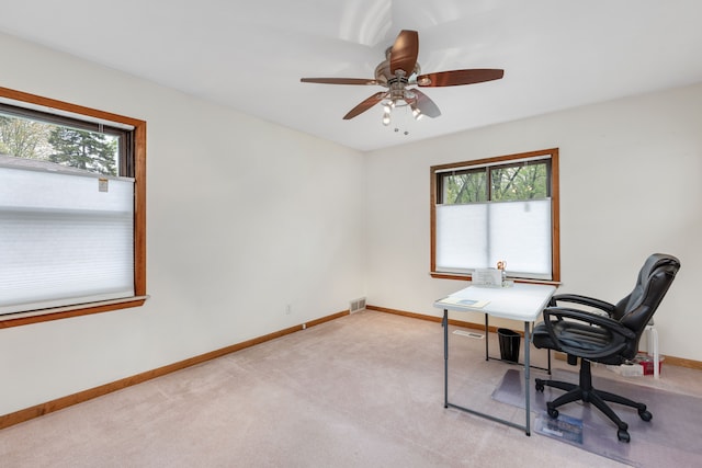office with a healthy amount of sunlight, baseboards, a ceiling fan, and visible vents